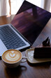 hot mocha with chocolate cake and laptop on the table
