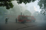Fototapeta Dziecięca - Fire trucks and firemen at the training of emergency fire drill in Hanoi