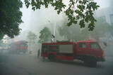 Fototapeta Dziecięca - Fire trucks and firemen at the training of emergency fire drill in Hanoi