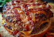A close-up view of a freshly cooked bacon cheeseburger placed on a wooden table, showcasing the juicy beef patty, melted cheese, crispy bacon strips, and soft burger bun.