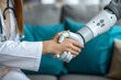 © anantachat - Human-Robot Collaboration: Surgeon and Robot Shake Hands in Close-up
