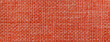 Texture of dark orange background from woven textile material with wicker pattern, macro. Vintage red fabric