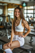 Young woman posing in gym setting