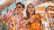 © HanThar Fusion - Asian couple having fun playing water guns wearing colorful patterned summer shirts on the street during Songkran Festival with water splash around them