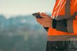 © Bits and Splits - Construction engineer using mobile smart phone on site during inspection