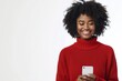 Portrait of smiling happy african american woman using smartphone isolated on white background, wearing red sweater with copy space for text or promotion banner.