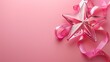 Metallic pink star balloon with decorative ribbon on a pink backdrop.