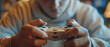 Close up of the hands of a teenage gamer holding a game controller, immersed in interactive digital entertainment