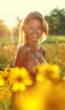 Cheerful young nude woman standing in flower field