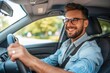 © ttonaorh - Handsome young man is driving a car and smiling driving a car with a clear view of the city through the window. showcasing safe driving with a seatbelt