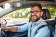 © ttonaorh - Handsome young man is driving a car and smiling driving a car with a clear view of the city through the window. showcasing safe driving with a seatbelt