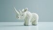 Fluffy white rhinoceros plush toy with a soft texture and playful appeal