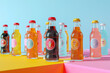 A vibrant collection of retro soda bottles with colorful labels on a multi-colored geometric background.