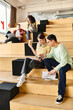© LIGHTFIELD STUDIOS - Multicultural group of students sitting atop stairs, engaged in conversation and contemplation