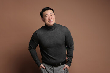 Canvas Print - Portrait of happy man on brown background