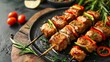 Grilled kebabs with skewers, meat, vegetables, tomatoes, and herbs on a wooden board