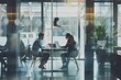 © alphaspirit - Two colleagues having a conversation with a laptop in a modern office environment