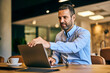 © bnenin - Businessman starting his workday at the office, opening a laptop.