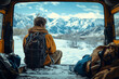 back of a single male traveler with a backpack sitting inside a camper van in nature by mountains in winter