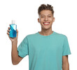 Young man with mouthwash on white background