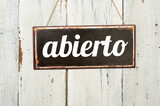 Fototapeta Nowy Jork - Vintage tin sign on a wooden background - Open in spanish