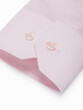 Light pink shirt cuff with buttons on a white background, close-up