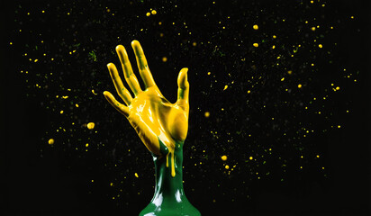 Wall Mural - yellow liquid splash on black background with small gold dots and dots