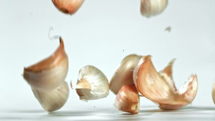 Canvas Print - Super slow motion garlic falls on the table. High quality FullHD footage