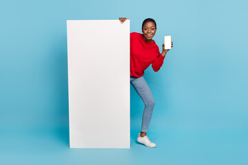 Sticker - Full body photo of impressed millennial lady near promo show telephone wear shirt jeans shoes isolated on blue background