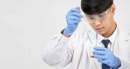 Wall Mural - Portrait asian man student scientist or doctor look hand holding reagent mixing laboratory in science research laboratory with test tubes of various size in  laboratory chemistry lab white background