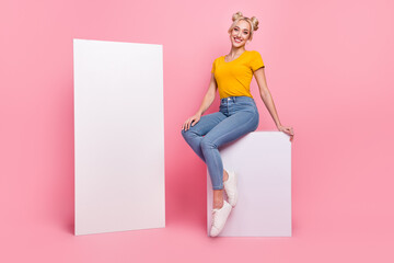 Sticker - Full length photo of optimistic blond lady sit near promo wear t-shirt jeans sneakers isolated on pink background