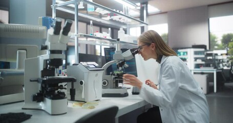 Aufkleber - Medical Research and Development Laboratory: Beautiful Caucasian Female Scientist Working on a Computer and Looking at a Sample in a Petri Dish Under a Microscope. Advanced Biotechnology Lab