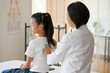 © DragonImages - Teenage girl visiting pediatrician for annual examination