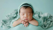 Cute studio photography of a newborn baby boy sleeping with cute props on soft blue background