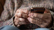 Elderly person using smartphone. Hands of old person using smartphone. Concept: Older adults using technology, making a call, threats and phishing, Internet fraud.