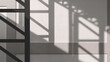Light and geometric shadow pattern of metal column of large pavilion on surface of concrete building wall background in monochrome and minimal style