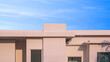 Beige single storey geometric contemporary house against blue sky background