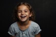 © sevenSkies - young italian child girl on plain bright black background laughing hysterically looking at camera background banner template ad marketing concept from Generative AI