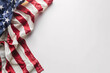 A fragment of the US flag on a white surface with copyspace for text. Background for design.