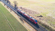 Aerial view of a passenger train driving through the countryside