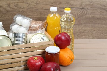 Wall Mural - Different donation food on wooden table, space for text