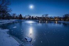 The Moon Casts Its Light On A Frozen Lake, Creating A Mesmerizing Scene