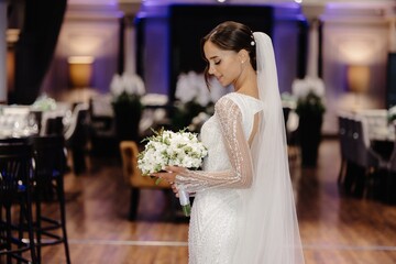 Timeless bride in white lace dress with bouquet, vintage feel on white background.