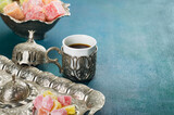 Fototapeta Sypialnia - Traditional turkish coffee and turkish delight on  blue-green wooden background