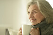 Senior elderly sick woman drinking tea at home