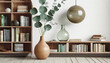 Living room interior featuring a contemporary design wooden bookcase, a eucalyptus leaf in a vase, books, decorations, a glass ball, and empty space on a white wall. Template included