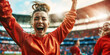 Cheerful female soccer player celebrating victory by raising hands and shouting out of joy on stadium