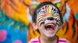 Exuberant Asian Child in Vibrant Tiger Face Makeup Roaring Playfully