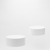 Fototapeta Mapy - Abstract scene - two round white tilt podiums for cosmetic products mockup, fly on white background. For presentation skin care products, gifts, goods, advertising, showing, sale in minimal style.