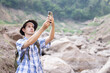 Caucasian man find mobile  signal on his mobile phone while hiking on the mountain